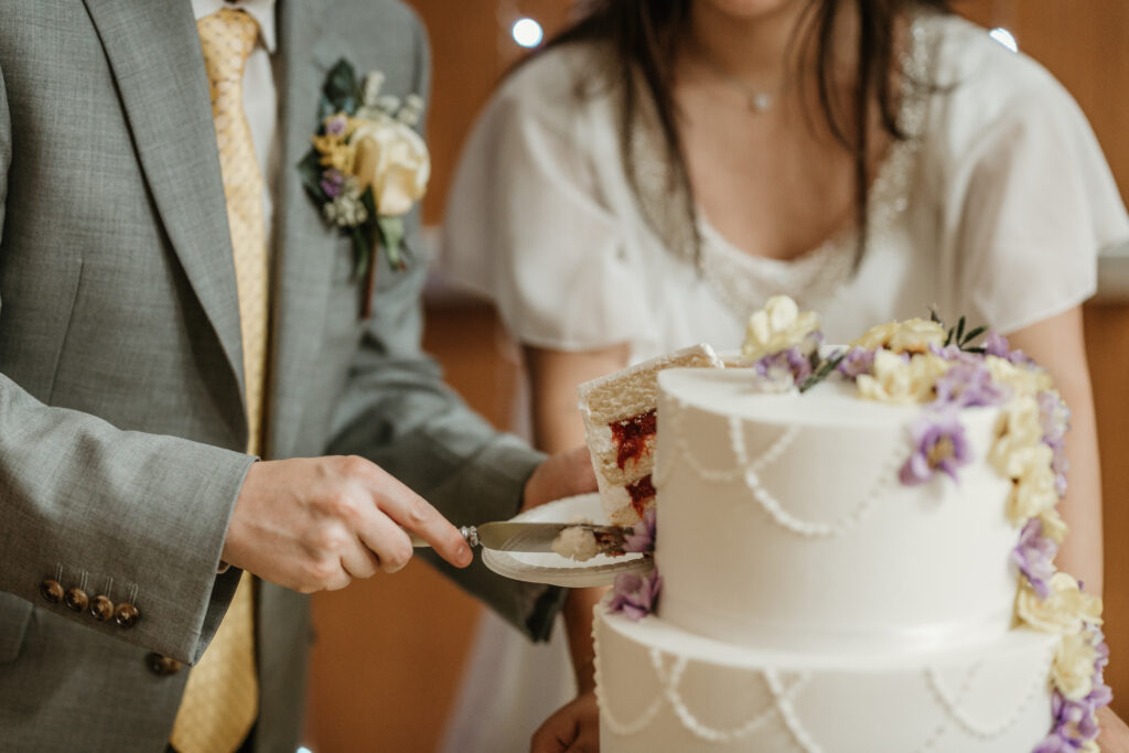 Bride and groom smiling after cutting the wedding cake at a lds/mormon church wedding held in Hemet, California