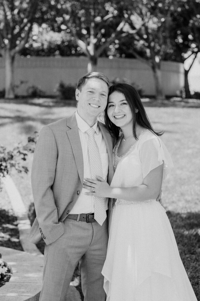 Black and white photo of couple on the Redlands LDS temple grounds on their wedding day.