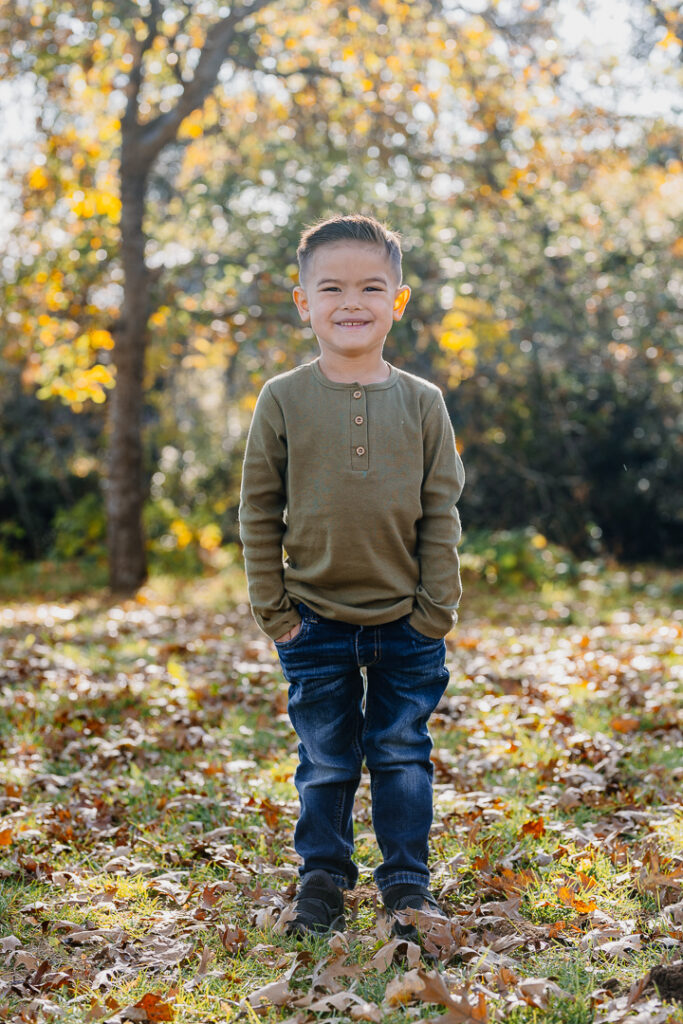 Young boy smiling in Oak Glen, CA for photoshoot. 