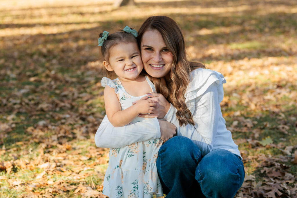 Young girl and mom smiling in Oak Glen, CA for photoshoot. 