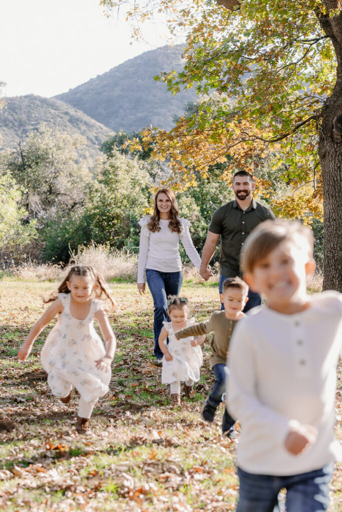 Family running around in Oak Glen, CA for photoshoot. 