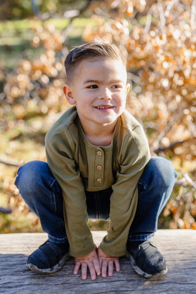 Young boy smiling in Oak Glen, CA for photoshoot. 