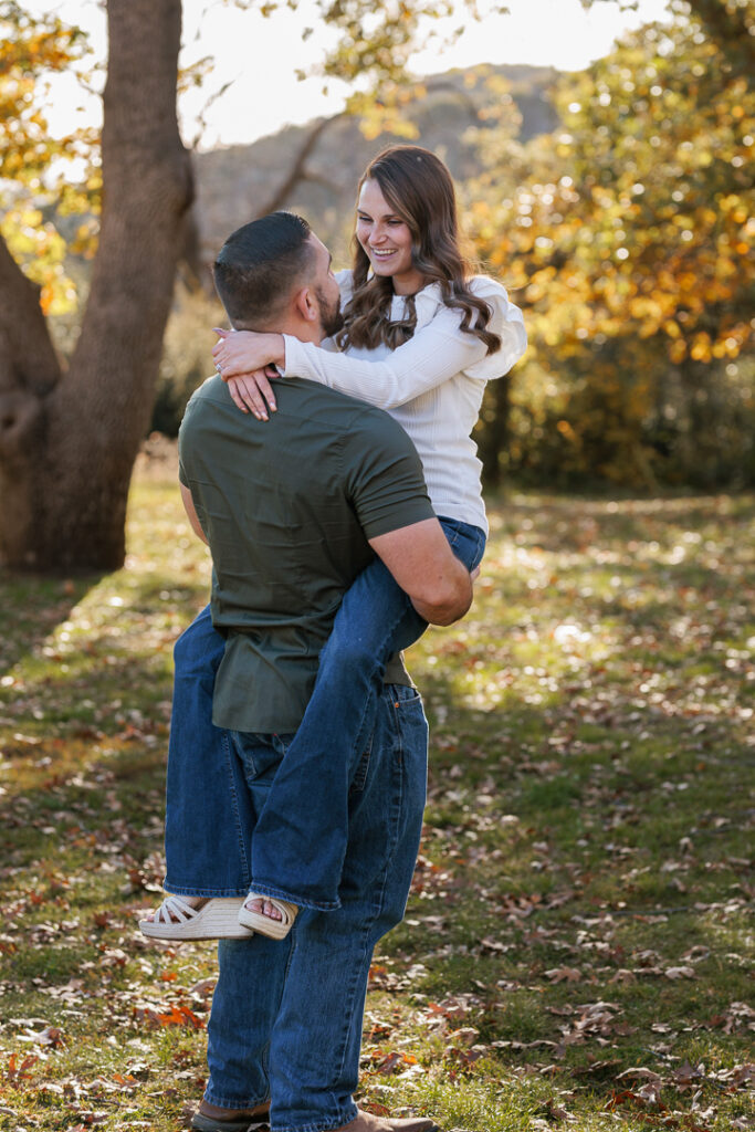 Sweet moment between mom and dad as they hug in Oak Glen, CA for photoshoot. 