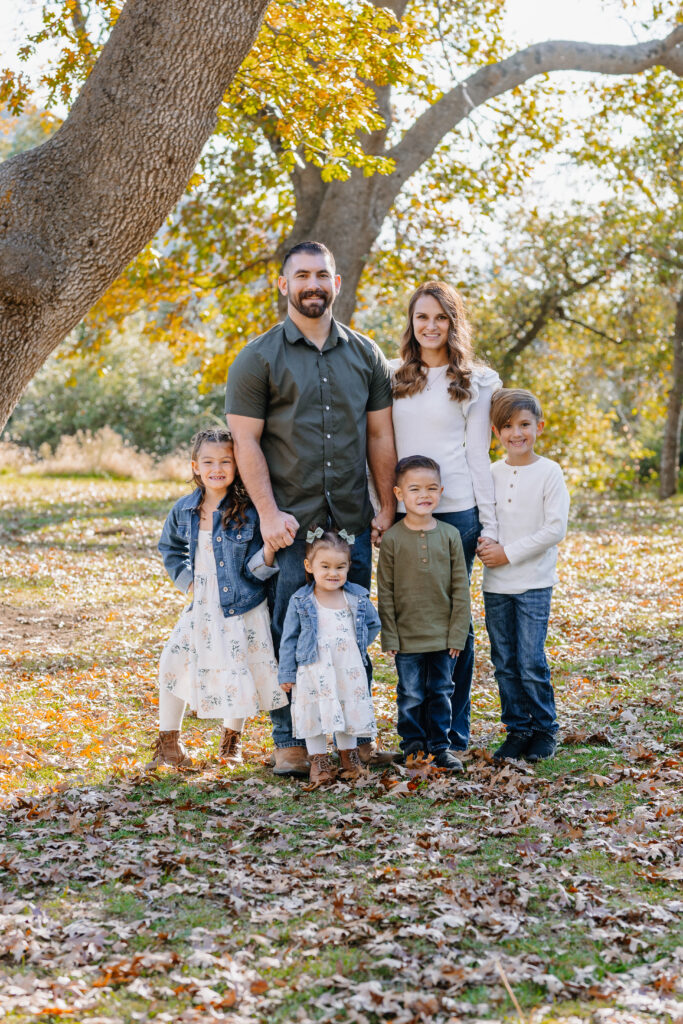 Group family photo in front of trees in Oak Glen California