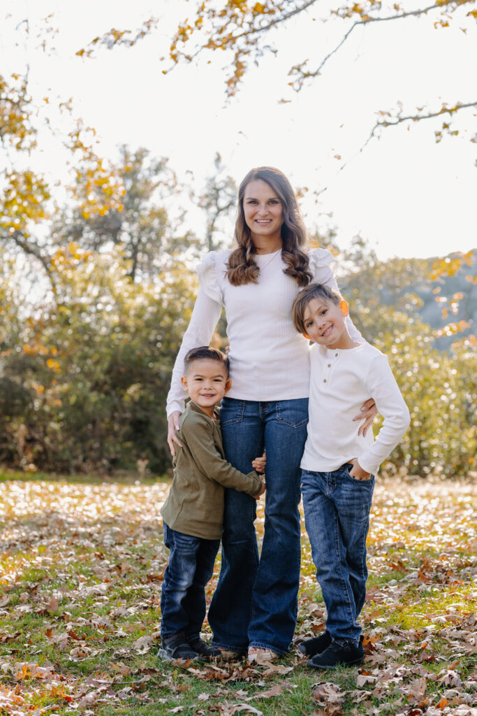 Mom and sons smiling in Oak Glen, CA for photoshoot. 